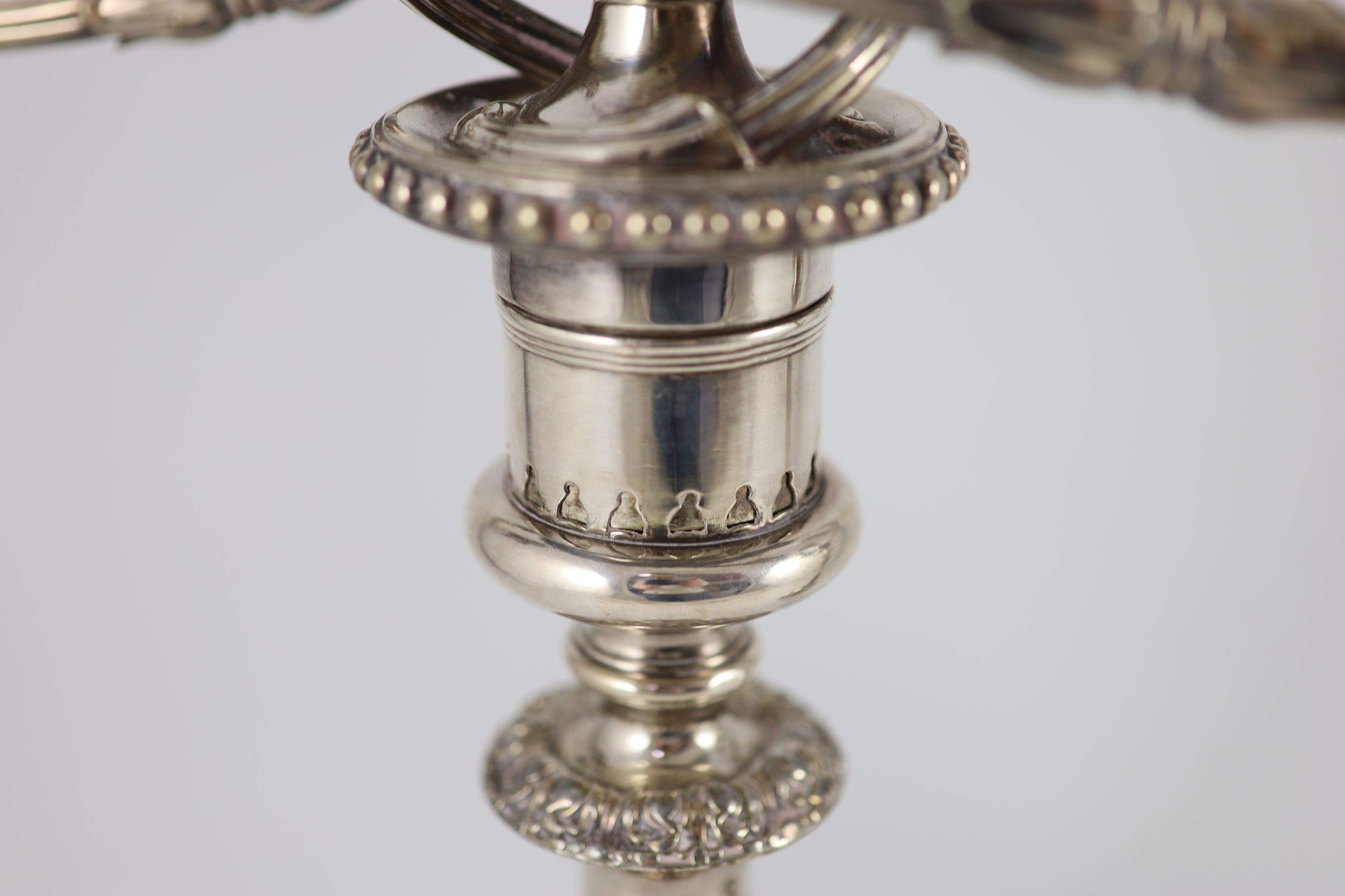 A pair of early to mid 20th century silver plated three light, two branch candelabra